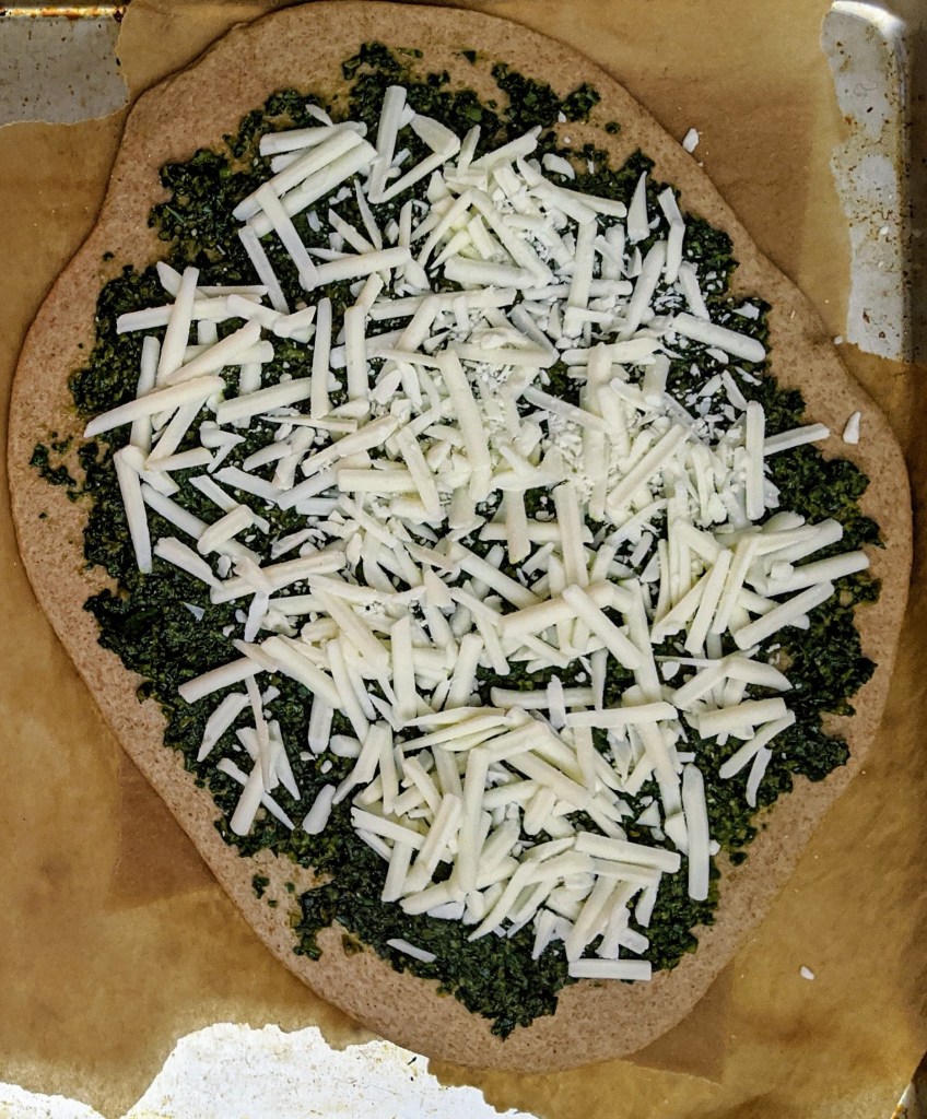 Pesto pizza on spelt dough with vegan mozzarella